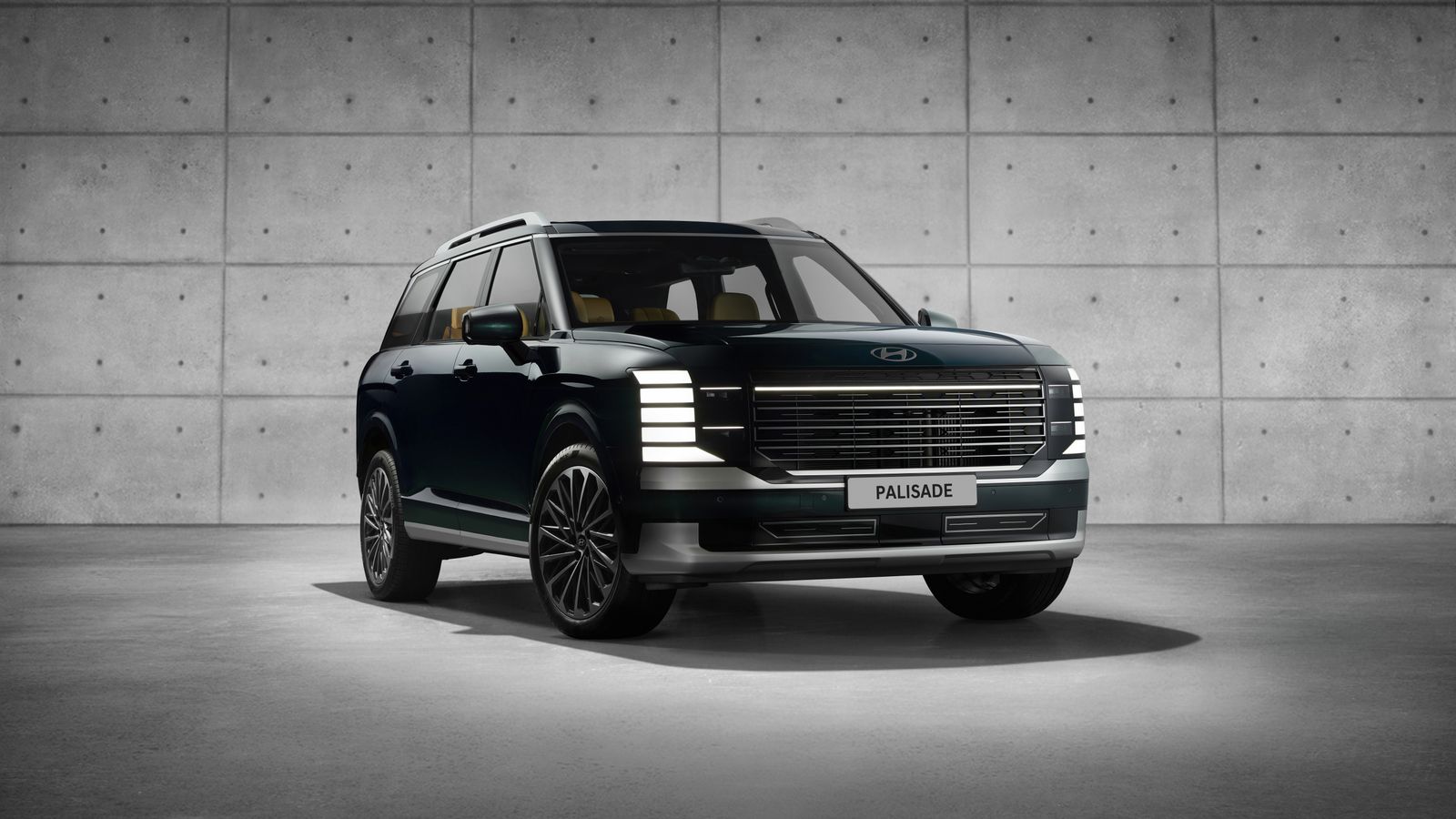 A family three-row SUV photographed in a clean studio setting.